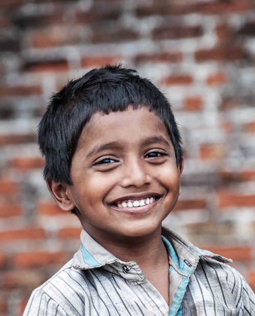 KOVALAM, INDIA - DEC 28, 2014: Portrait of unidentified Indian boy on the street in fishing village. Kovalam. Kerala. India